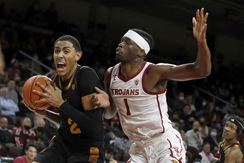 Arizona State forward Jalen Graham, left, drives past USC forward Chevez Goodwin during the first half Monday.