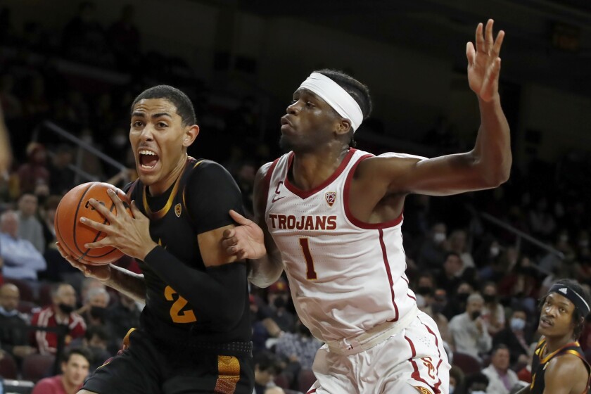 Arizona State forward Jalen Graham, left, passes USC forward Chevez Goodwin during the first half on Monday.