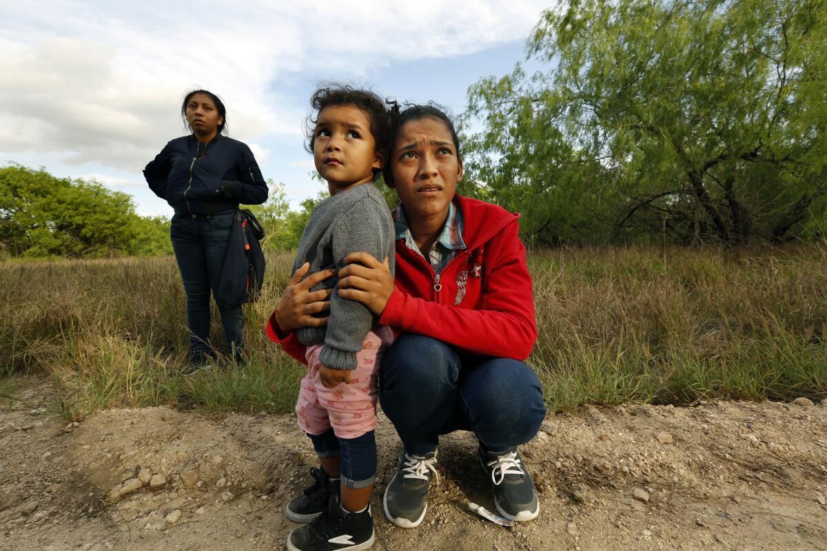 Lirio Funes, age 20, holds onto her daughter Melissa Funes, age 2, just after being detained by local officials.
