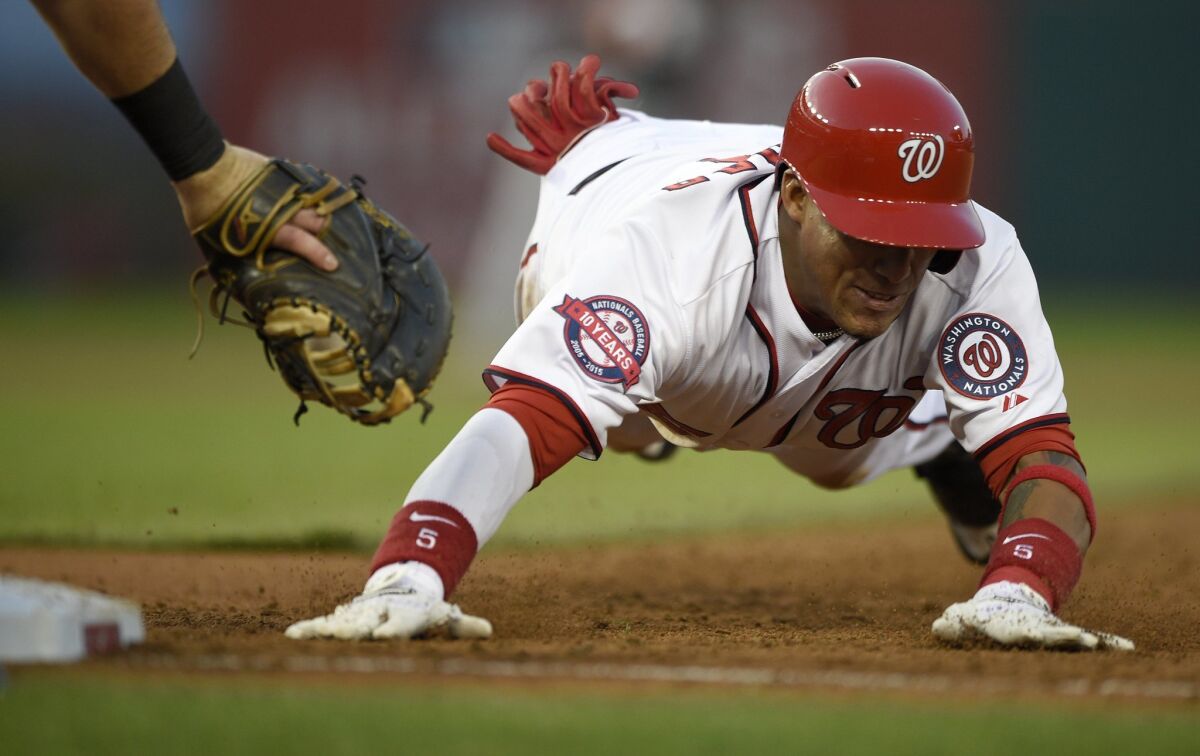 Washington's Yunel Escobar, who is said to be headed for the Angels, dives back to first against Miami on May 4.