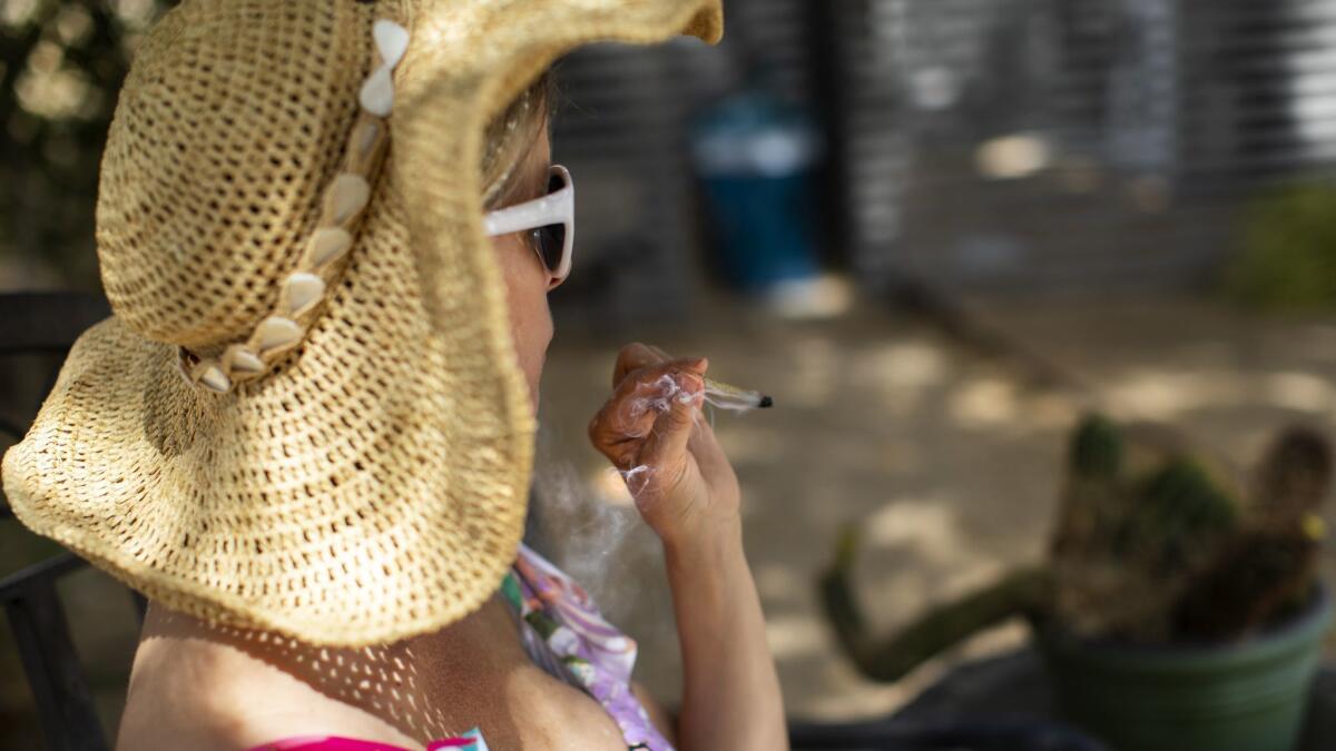 Chevyn McClintock enjoys a marijuana joint at the pot-friendly Desert Hot Springs Inn. The hotel is one of only a handful in California that welcome pot smokers but the trend may be growing.