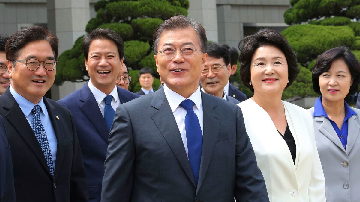 South Korean President Moon Jae-in, center, arrives to leave for the United States at the Seoul military airport in South Korea.