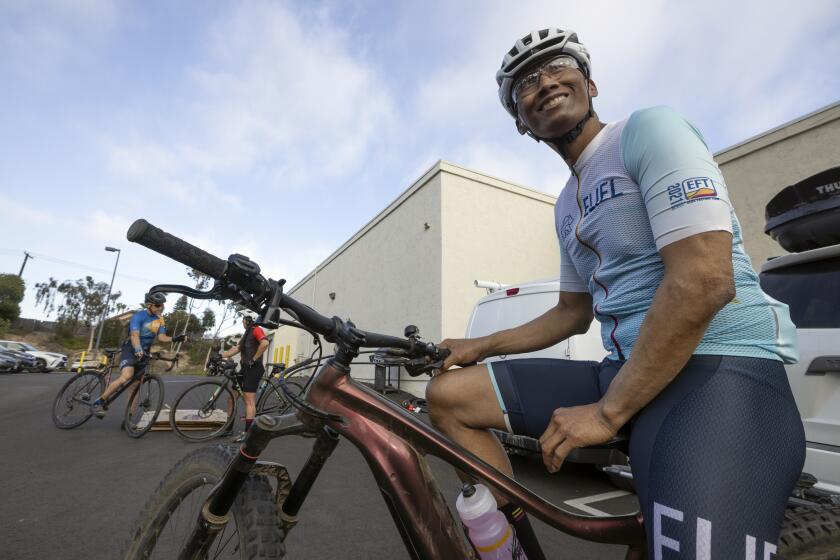 ENCINITAS, CA - JUNE 9, 2022: Robert Duran, 55, who has had pancreatic cancer since 2014, sits on his trail bike as he and friends gather at El Camino Bike Shop in Encinitas to go for a 15 mile bike ride together after Duran's weekly chemotherapy treatment on Thursday, June 9, 2022. (Hayne Palmour IV / For The San Diego Union-Tribune)