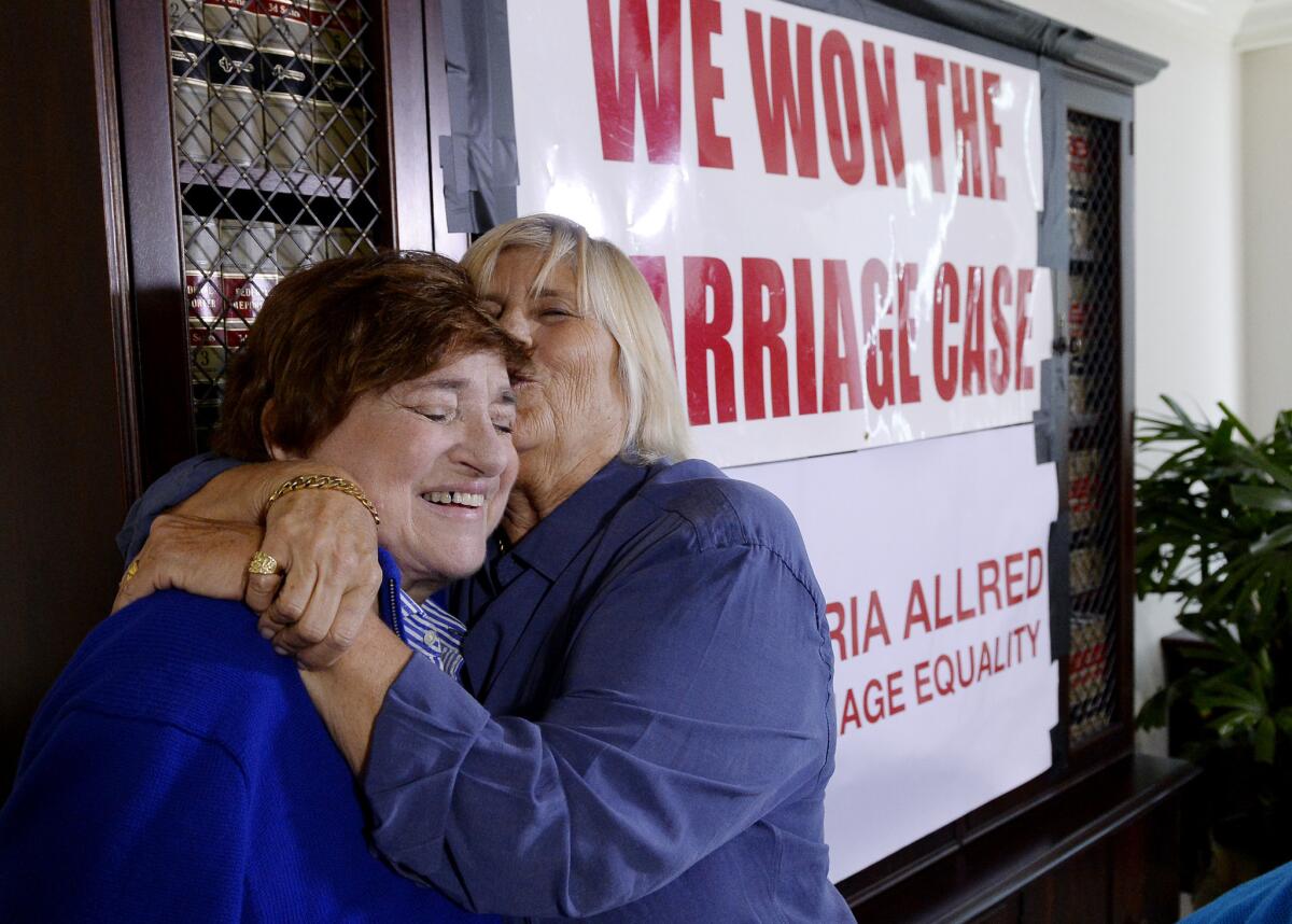 Diane Olson, right, kisses her spouse, Robin Tyler, at attorney Gloria Allred's office after the Supreme Court's ruling on same sex-marriage.