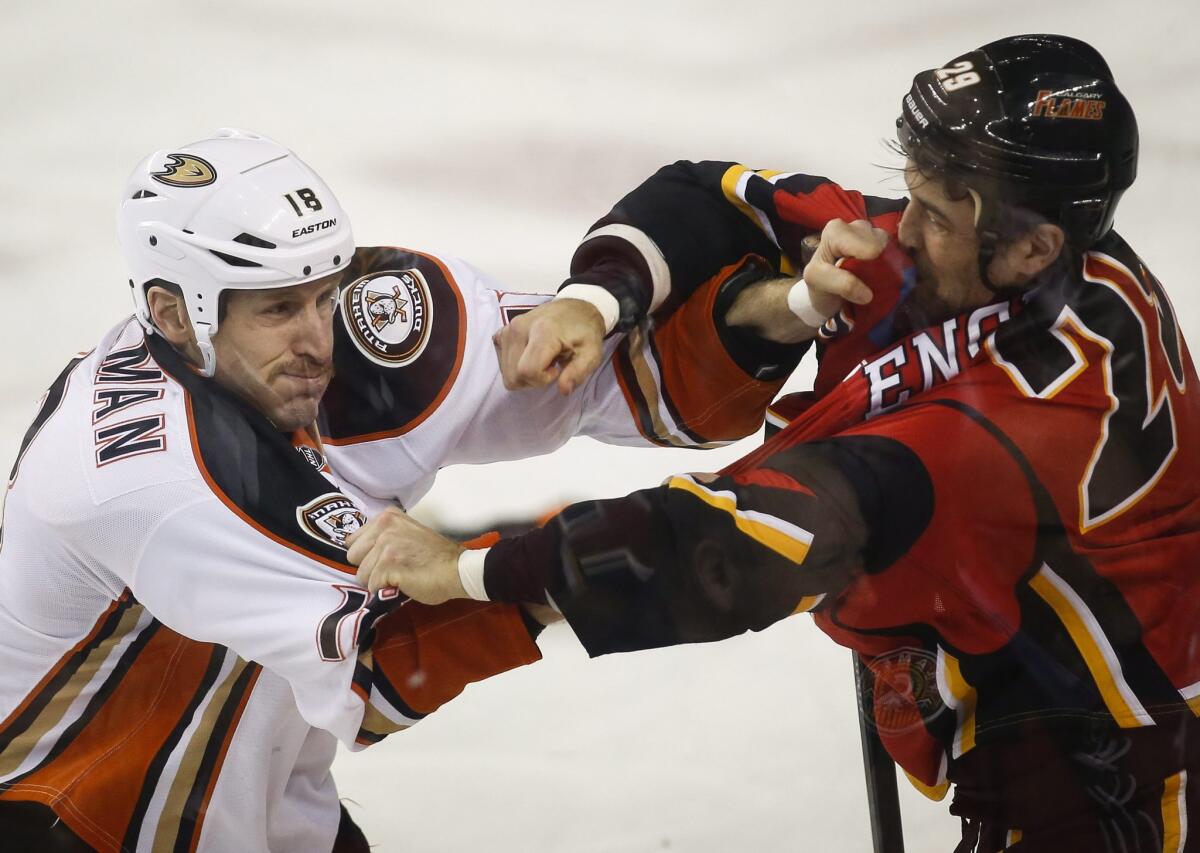 Ducks defensman Tim Jackman and Calgary defenseman Deryk Engelland fight during the first period of a game on Nov. 18. The Flames beat the Ducks, 4-3, in a shootout.