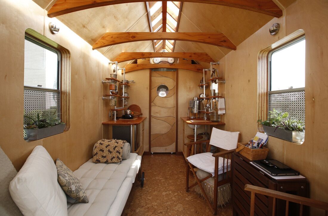 A look at the interior of Nomad, Dominique Moody's 100-square-foot home on wheels made out of recycled materials. This main room functions as sleeping, eating, sitting and cooking area.