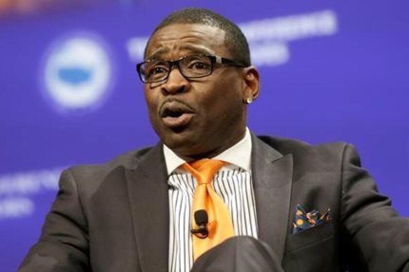 Former Dallas Cowboys player Michael Irvin speaks during a panel discussion on race and sports at the U.S. Conference of Mayors meeting Monday, June 23, 2014, in Dallas. (AP Photo/LM Otero)