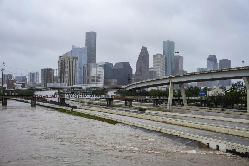 Floodwaters rise next to the I-10 freeway just after Hurricane Beryl made landfall, Monday, July 8, 2024, in Houston. (Raquel Natalicchio/Houston Chronicle via AP)