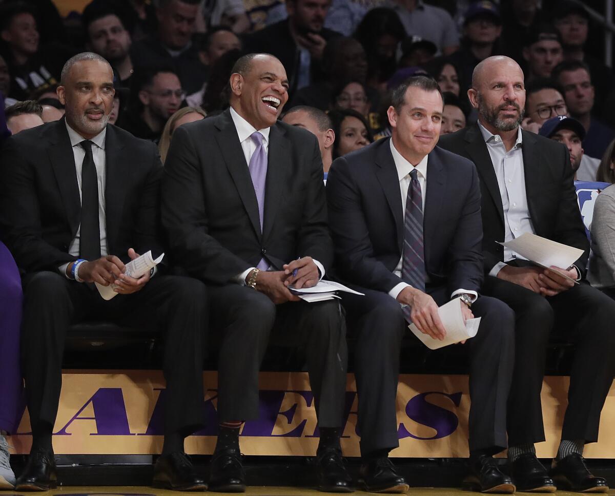 Lakers coach Frank Vogel on the bench with his top assistants, from left, Phil Handy, Lionel Hollins and Jason Kidd.