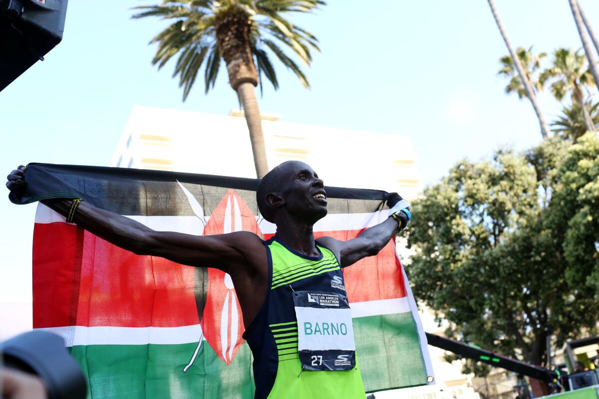 Runner Elisha Barno celebrates finishing in first place during the Los Angeles Marathon on Sunday.