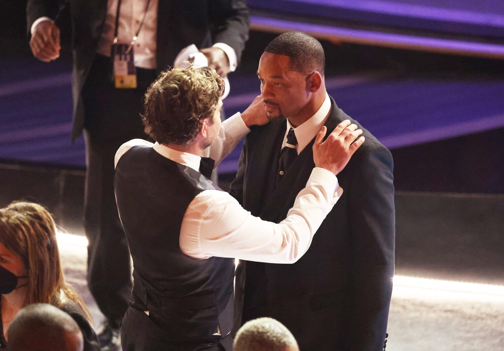 Bradley Cooper comforts Will Smith during the 94th Academy Awards at the Dolby Theatre.