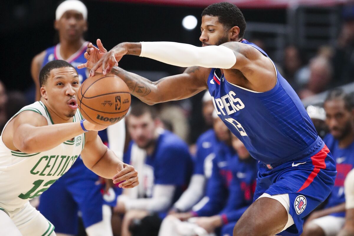 Clippers guard Paul George and Boston Celtics forward Grant Williams battle for loose ball.