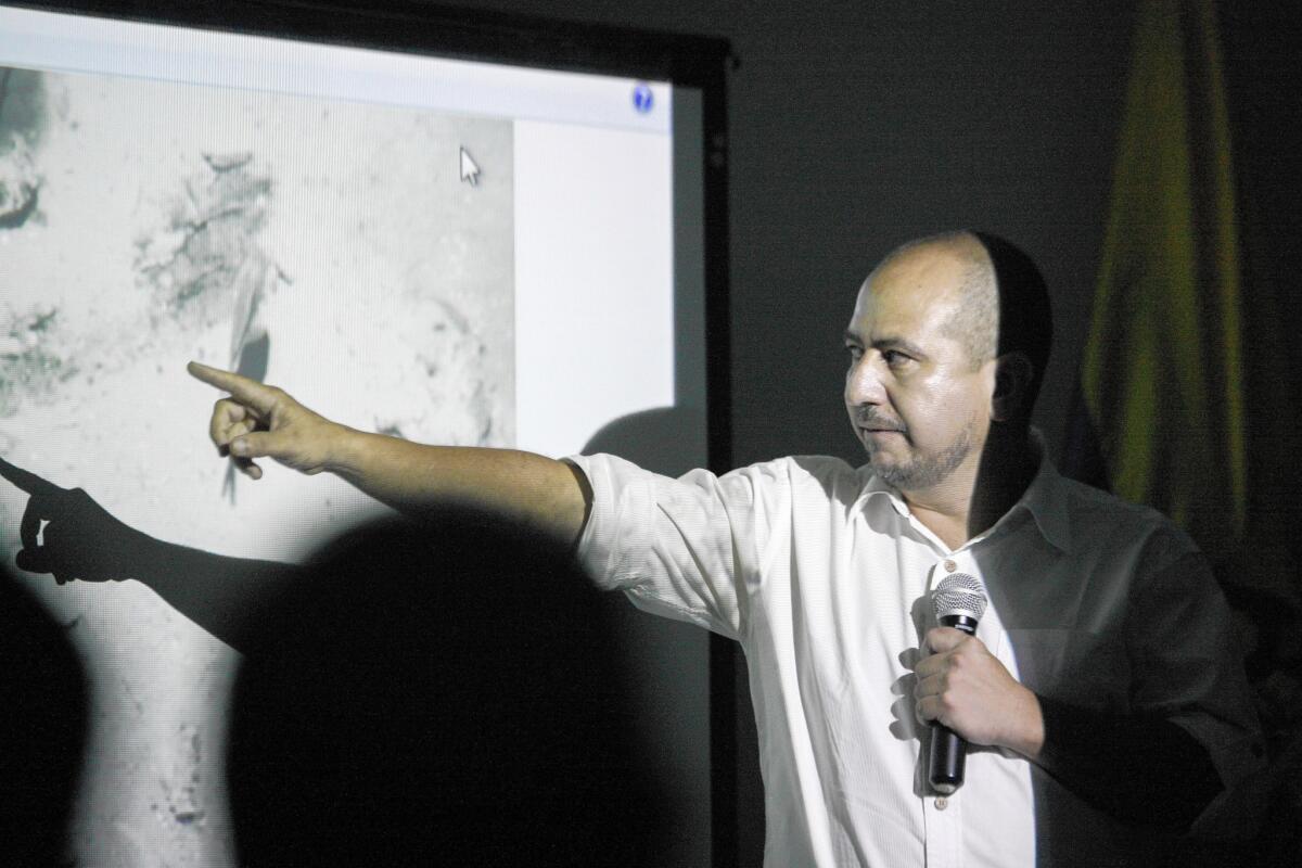 Ernesto Montenegro, director of the Colombian Institute of Anthropology and History of Colombia, shows a picture of the shipwreck at a news conference last month in Cartagena.