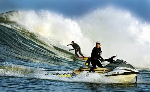 Rescue expert Shawn Alladio rides a personal watercraft, ready to tow in surfer Marcelo Ulyssea at Maverick's near Half Moon Bay. The National Marine Sanctuary is considering a ban on personal watercraft at the hard-to-reach spot whose 40- to 60-foot waves draw surfers from around the world.