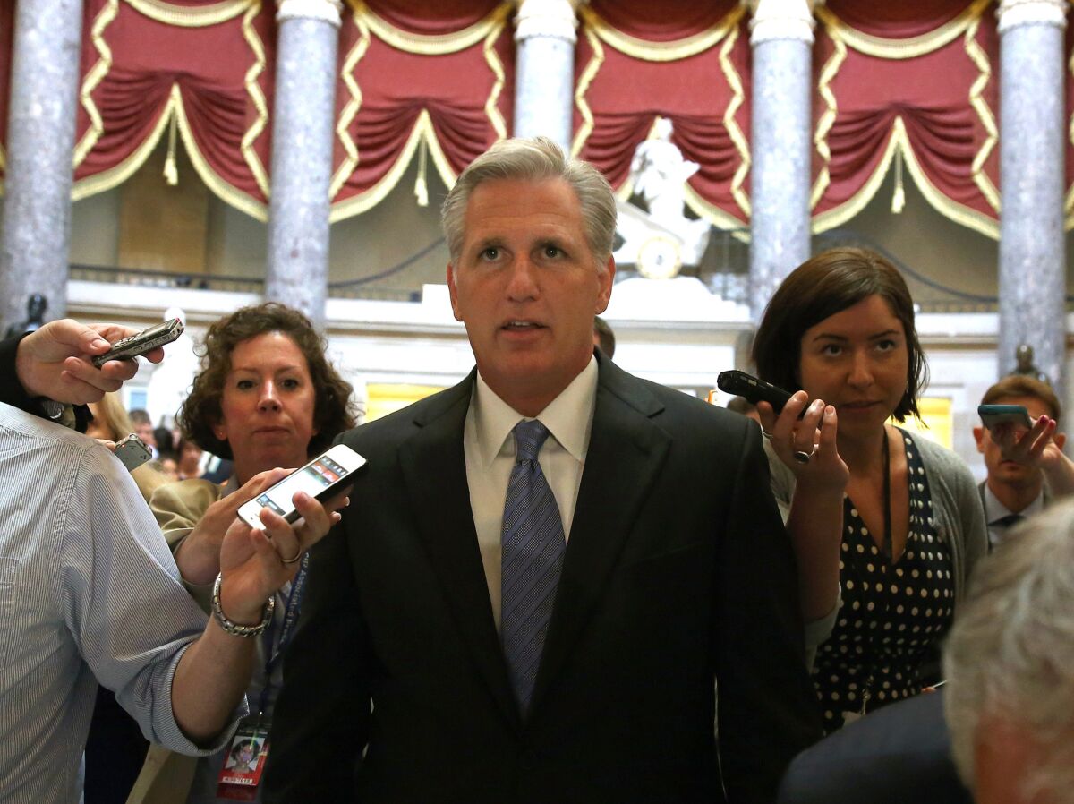 Rep. Kevin McCarthy is trailed by reporters while walking in the U.S. Capitol building Wednesday. McCarthy, the leading contender for House majority leader, opposes California's bullet train project.