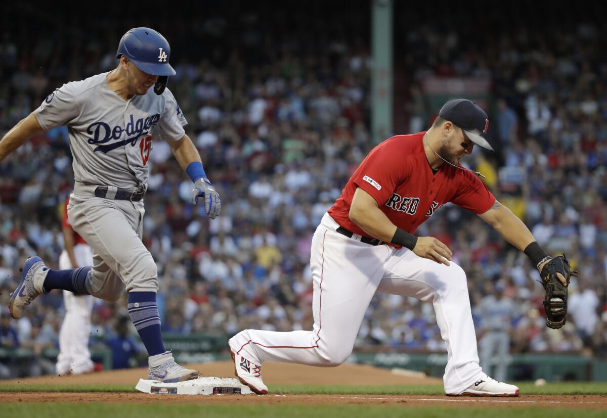 Dodgers catcher Austin Barnes is out at first on a ground ball as Boston Red Sox first baseman Michael Chavis catches the throw from third during the second inning on Friday in Boston.