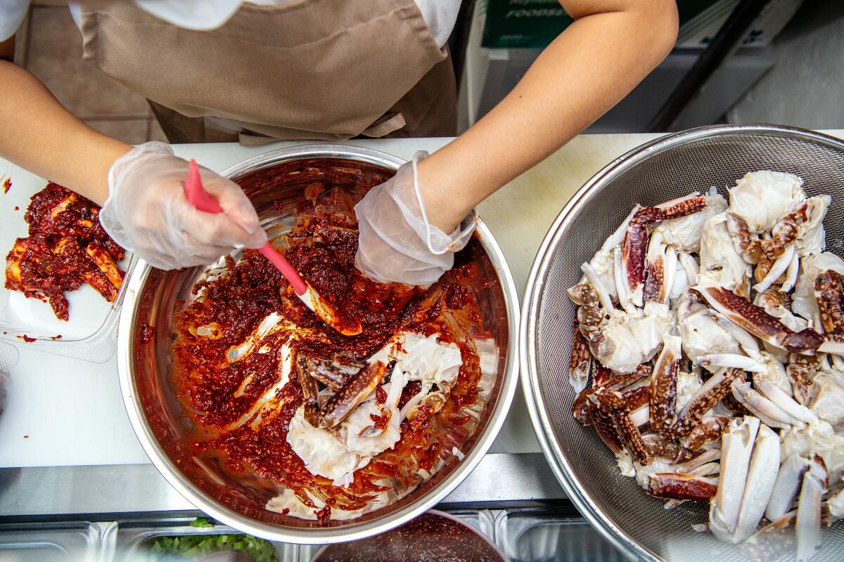 Lucy Row preps a spicy marinated crab dish