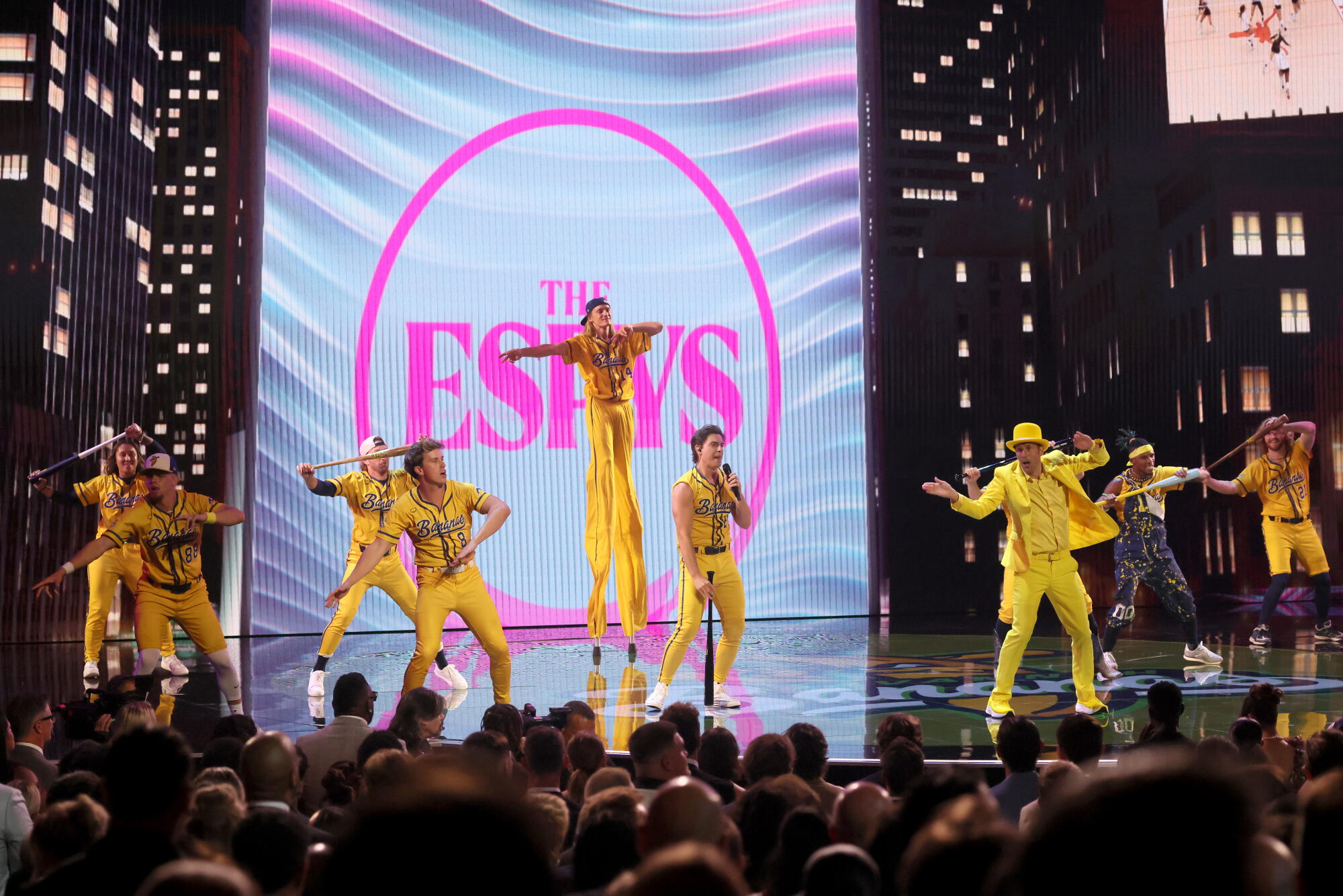 A group of men successful agleam yellowish creation onstage.