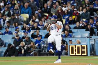 LOS ANGELES, CA - MARCH 30: Los Angeles Dodgers starting pitcher Julio Urias (7) delivers a pitch in front of the pitch clock during the first inning against the Arizona Diamondbacks at Dodger Stadium on Thursday, March 30, 2023 in Los Angeles, CA.(Gina Ferazzi / Los Angeles Times)