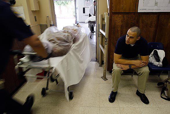 Marine Corps Reserve Lance Cpl. Matthew Barlow begins a shift at the Los Angeles County coroner's office, where he was among 14 Marines embedded for three weeks to learn how to collect bodies and personal belongings and identify the dead. The troops are in a special unit that soon will deploy to Iraq, where they will receive the bodies of fallen troops and prepare them for the flight home to the United States.