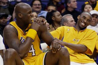 Lakers Shaquille O'Neal and Kobe Bryant share a laugh on the bench during the 2003 season