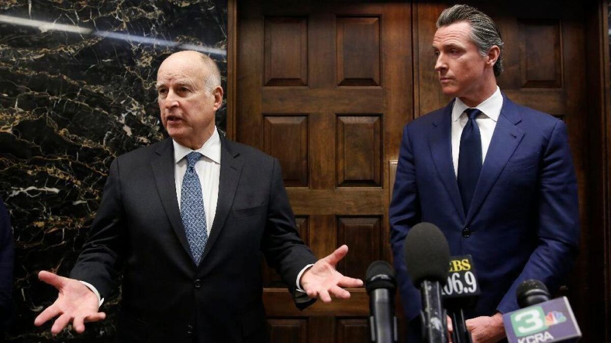 Outgoing Gov. Jerry Brown speaks with reporters after a meeting with Gov.-elect Gavin Newsom in Sacramento on Nov. 13.