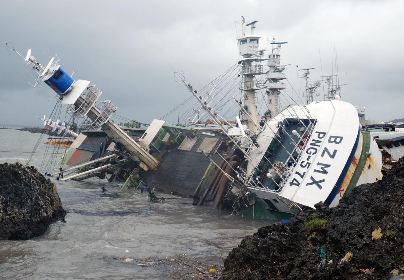 An overturned fishing boat lies in the aftermath of Typhoon Meranti in Kaohsiung, Taiwan. Parts of Taiwan came to a standstill as the powerful storm brought the strongest winds the country has seen in 21 years. China issued a red alert for waves as the storm bore down on the mainland.