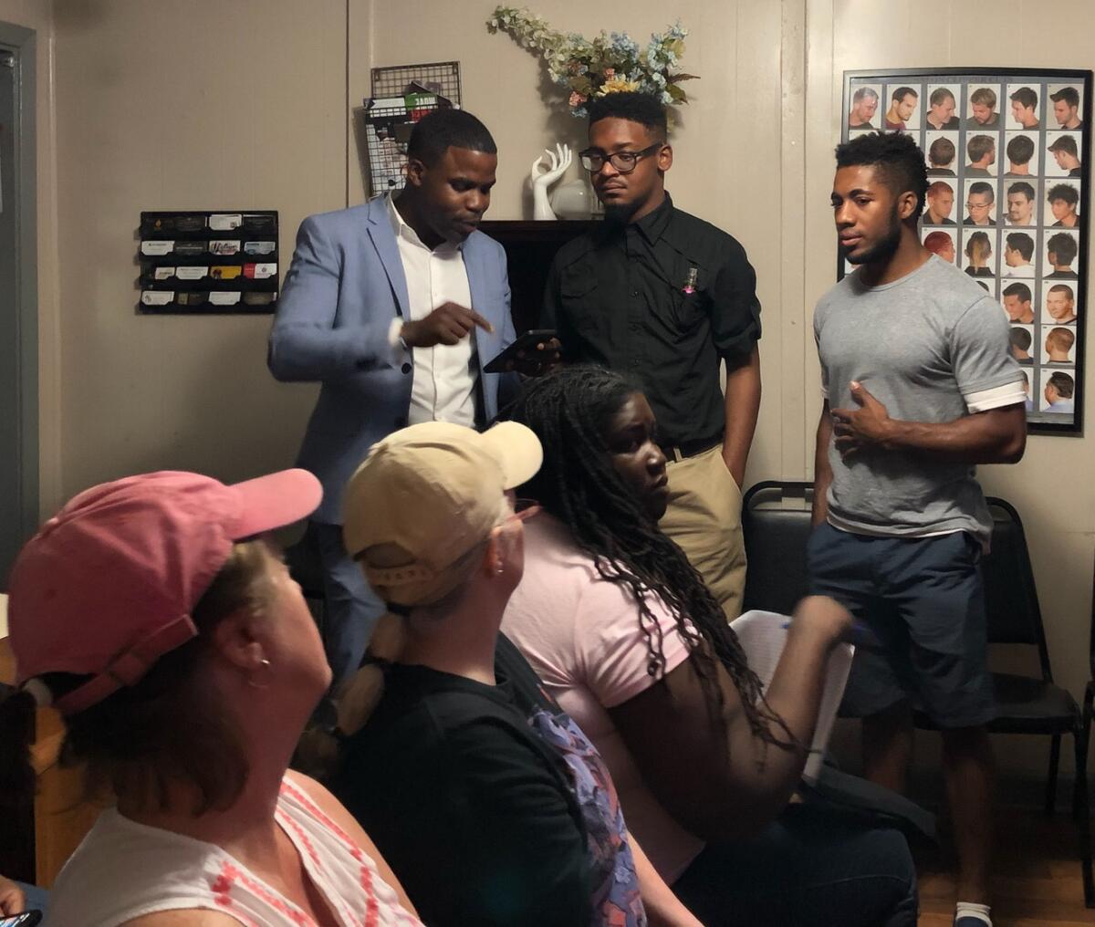 South Carolina state Rep. J.A. Moore, left, speaks with guests at a Democratic debate watch party  in 2019. 