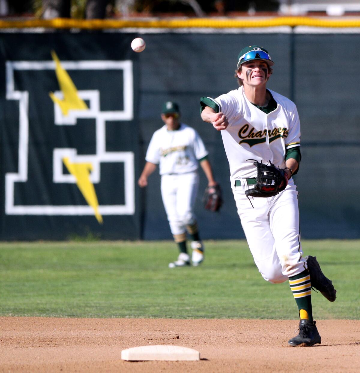 Edison infielder Tyler Weaver, shown throwing out a runner on March 6 against Laguna Beach, was honored as a Sunset Conference "Dream Team" selection.