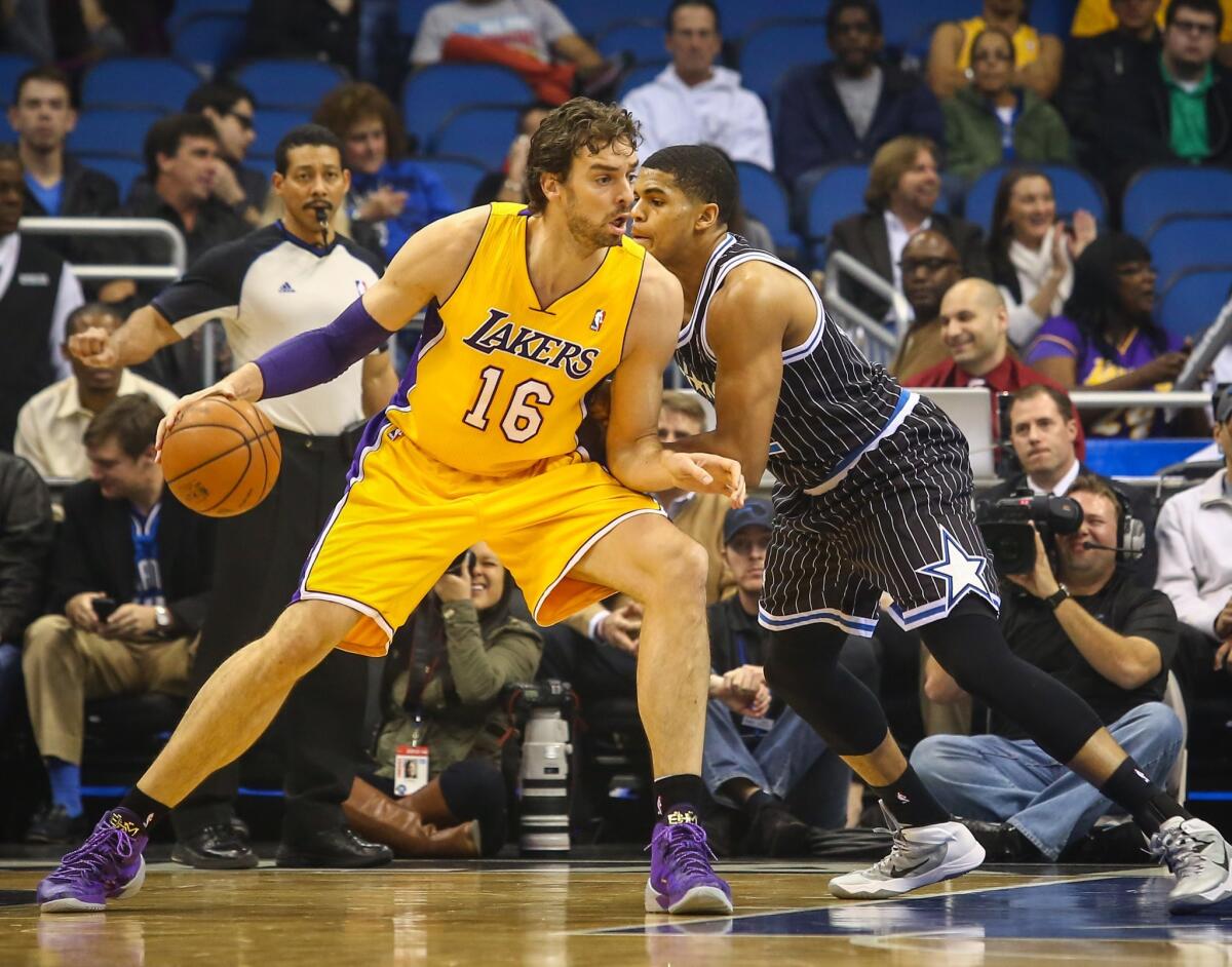 Lakers power forward Pau Gasol works in the post against Magic forward Tobias Harris in the first half Friday night in Orlando.