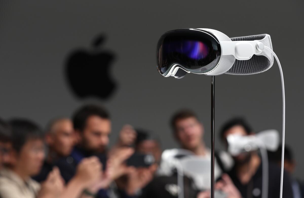 Apple's Vision Pro headset is displayed on a stand.