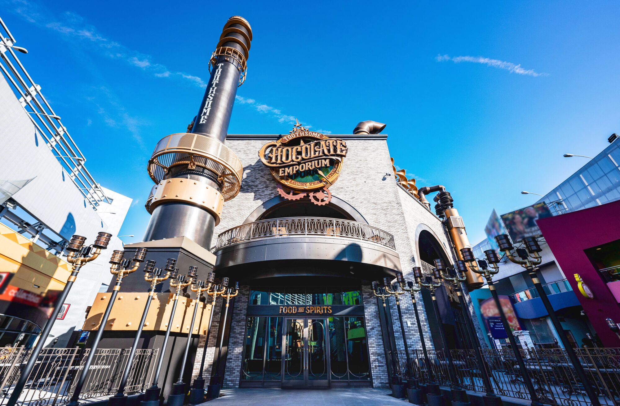 Toothsome Chocolate Emporium exterior has steampunk feel with tall embellished metal pipes and old fashioned street lamps.
