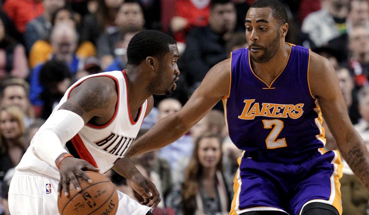 Lakers guard Wayne Ellington cuts off a drive by Trail Blazers guard Wes Matthews during their game Monday in Portland.