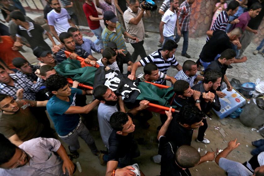 Palestinian mourners carry the body of Mohammed Fasih, who was killed in an Israeli airstrike Friday.