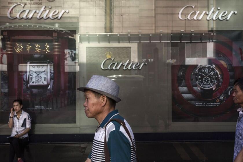BEIJING, CHINA - AUGUST 28: Chinese shoppers walk passed a luxury store in an upscale shopping district on August 28, 2015 in Beijing, China. China's government is relying on domestic consumption and services to sustain economic growth amid a slowdown in manufacturing and exports. Concerns about cracks in the world's second largest economy triggered a dramatic sell-off on global stock markets. China's government intervened to stop the rout by pumping billons of dollars in liquidity into its markets, cracking down on institutional selling and cutting interest rates for the fifth time in less than a year. (Photo by Kevin Frayer/Getty Images) ** OUTS - ELSENT, FPG - OUTS * NM, PH, VA if sourced by CT, LA or MoD **