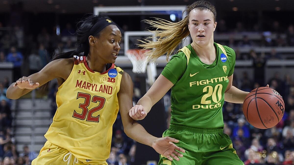 Oregon's Sabrina Ionescu (20) protects the ball from Maryland's Shatori Walker-Kimbrough while setting up the offense during the second half Saturday. (Jessica Hill / Associated Press)