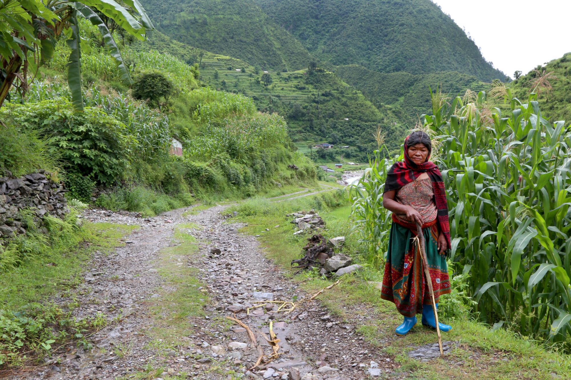 Subitra Bhandari, who is now 74 years old, prepares to walk toward the nearest town outside Adhikarichaur, Nepal.