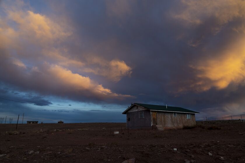 CAMERON, AZ - MARCH 27, 2020: Storm clouds pass over one of many rural homes on the Navajo reservation which do not have electricity or running water during the coronavirus pandemic on March 27, 2020 in Cameron, Arizona. Now, more than 75 Navajos have tested positive. (Gina Ferazzi/Los AngelesTimes)