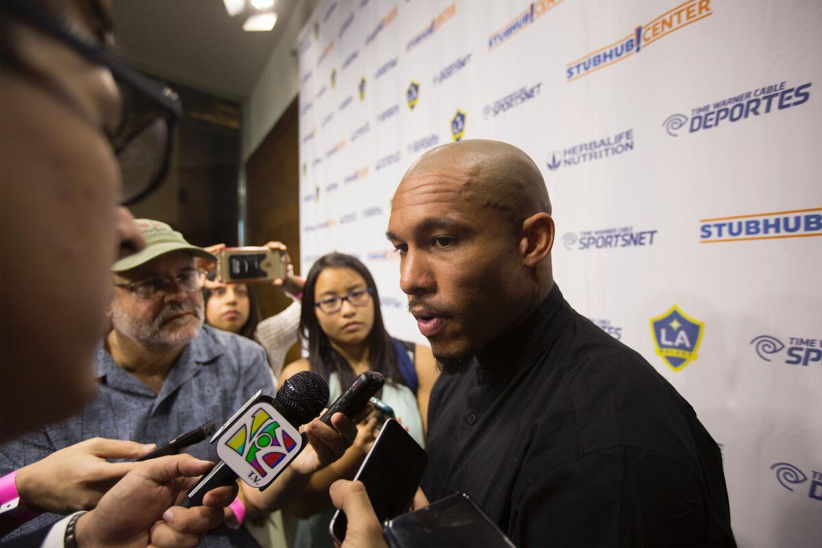 Midfielder Nigel de Jong talks to reporters after signing with the Galaxy on Feb. 16.