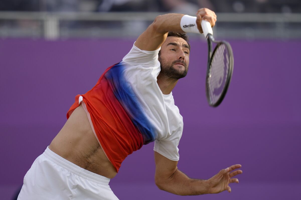 Marin Cilic of Croatia serves to Alexander Bublik of Kazakhstan during their singles tennis match at the Queen's Club Championships in London, Wednesday, June 15, 2022. (AP Photo/Kirsty Wigglesworth)