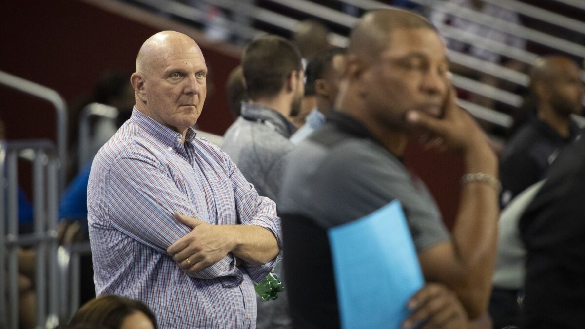 Clippers owner Steve Ballmer, left, and coach Doc Rivers watch the team during practice at the USC Galen Center.