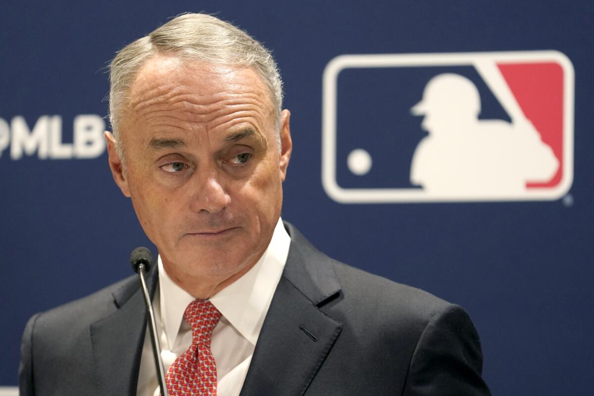 Major League Baseball commissioner Rob Manfred listens to a question.