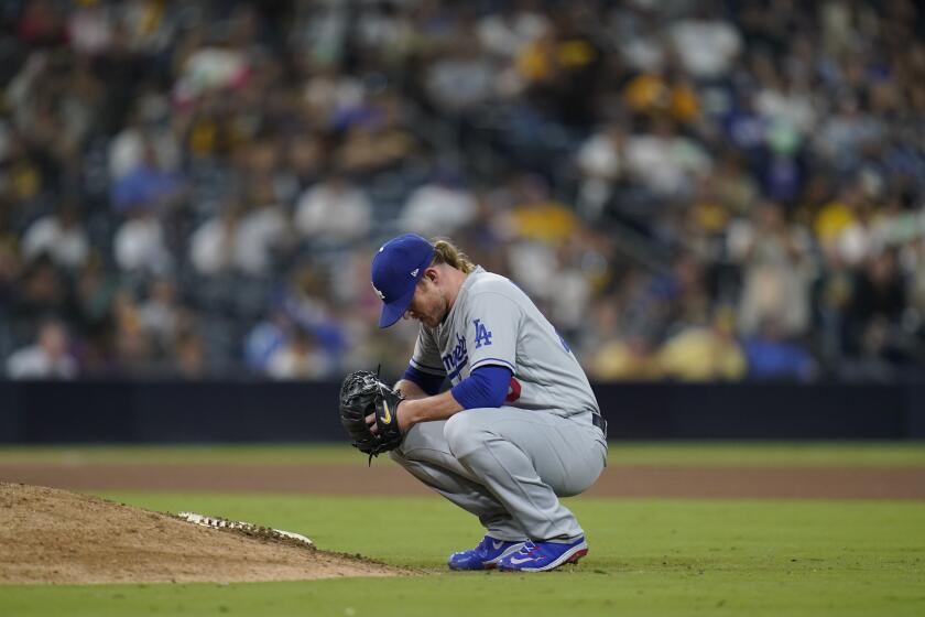 Los Angeles Dodgers relief pitcher Craig Kimbrel takes a moment before facing a San Diego Padres batter during the 10th inning of a baseball game Tuesday, Sept. 27, 2022, in San Diego. (AP Photo/Gregory Bull)