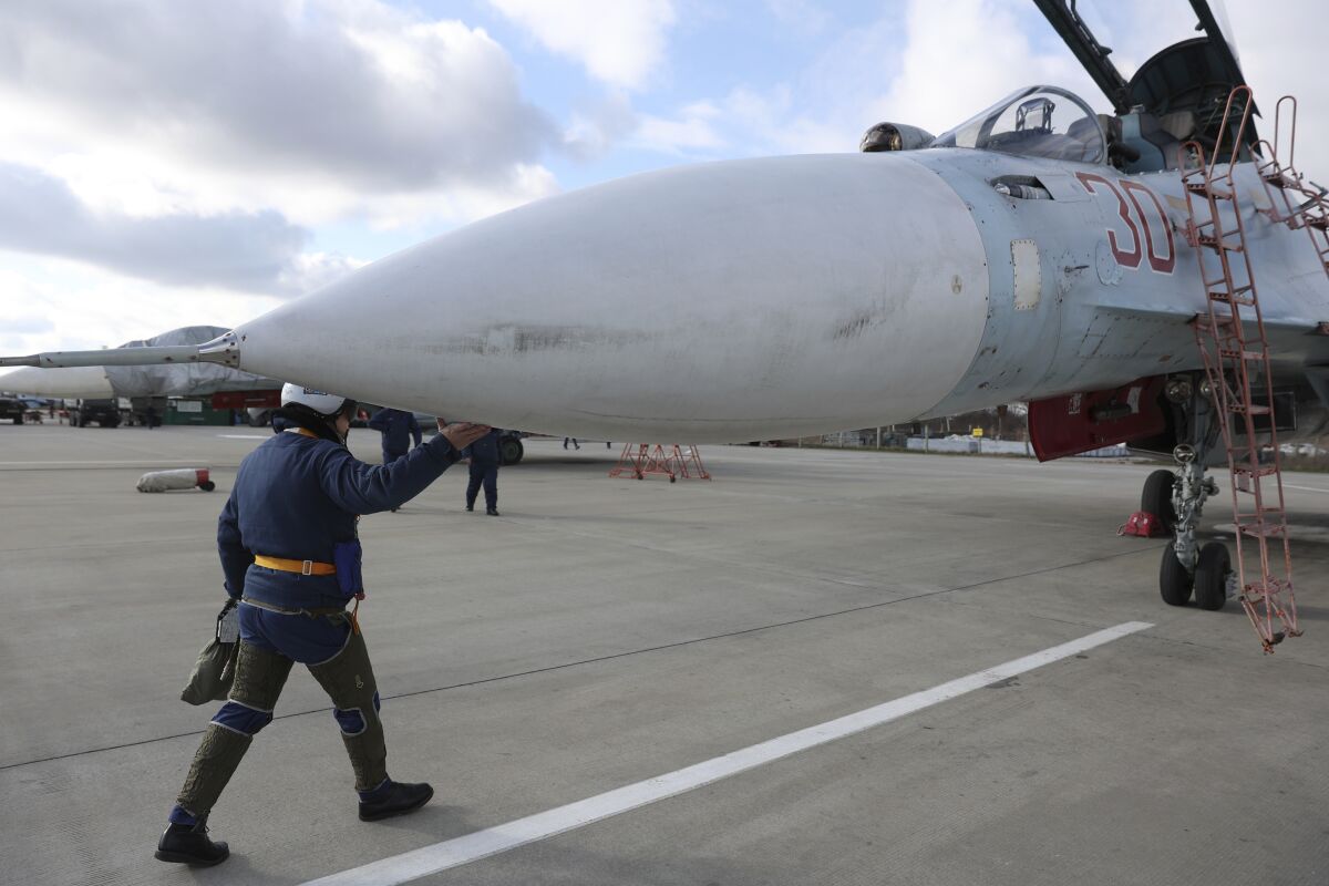 A Russian air force pilot walks to aSu-30 fighter jet before a training mission in Krasnodar Region, Russia, Wednesday, Jan. 19, 2022. (AP Photo/Vitaliy Timkiv)