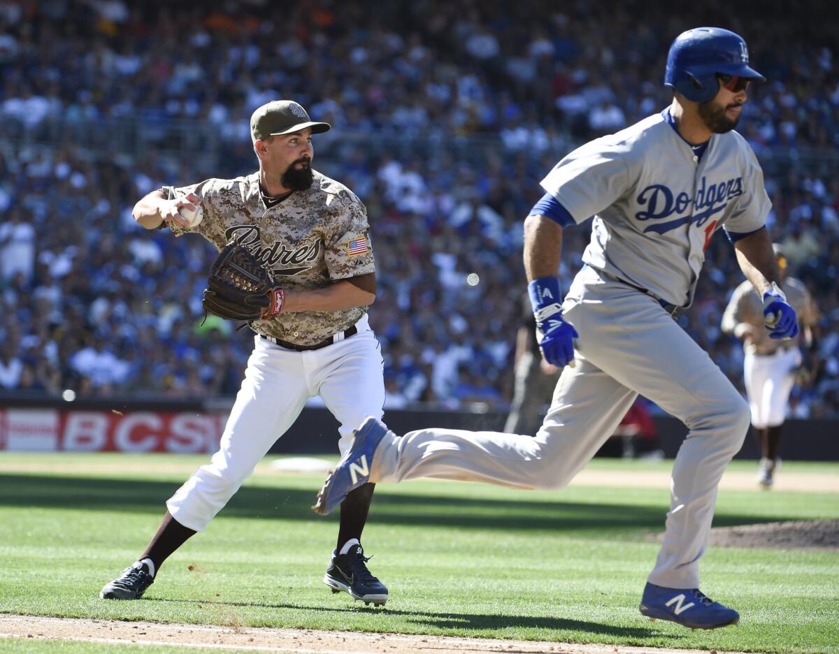 Padres reliever Nick Vincent throws errantly to first base on a dribbler off the bat of Dodgers outfielder Andre Ethier during the seventh inning. Vincent's error allowed three runs to score.