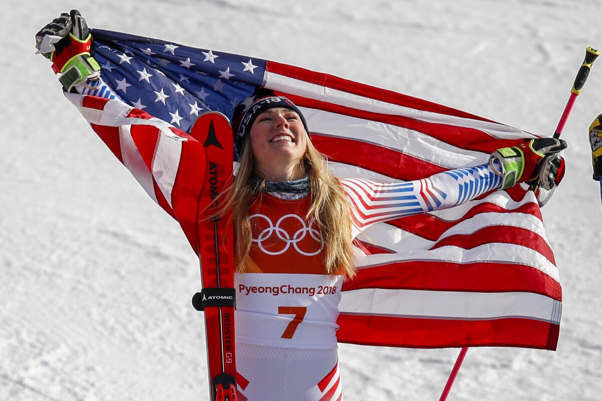 FILE - Mikaela Shiffrin, of the United States, celebrates her gold medal during the venue ceremony at the women's giant slalom at the 2018 Winter Olympics in Pyeongchang, South Korea, Feb. 15, 2018. Shiffrin will defend her giant slalom gold medal in the first women's Alpine skiing event of the Beijing Olympics. (AP Photo/Jae C. Hong, File)