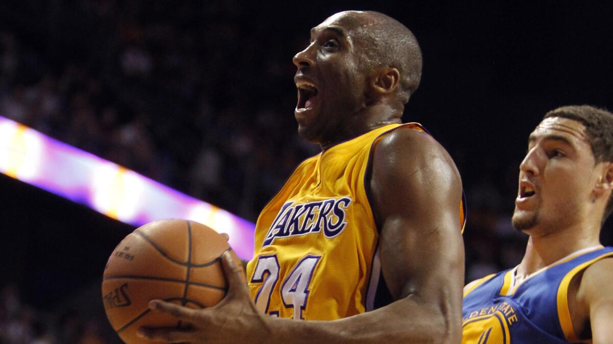 Lakers star Kobe Bryant, left, puts up a shot in front of Golden State's Klay Thompson during a Lakers exhibition loss on Oct. 12.