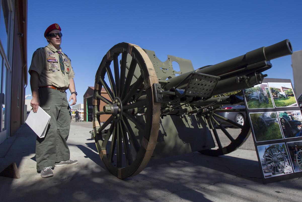 Brenden Fettis, 17, stands next to the US Army M1902 field gun that he restored as his Eagle Scout project. The gun will go back to its home in front of the Costa Mesa Police Department sub station on 18th Street. Photo taken on Thursday, December 26. (Scott Smeltzer, Coastline Pilot)