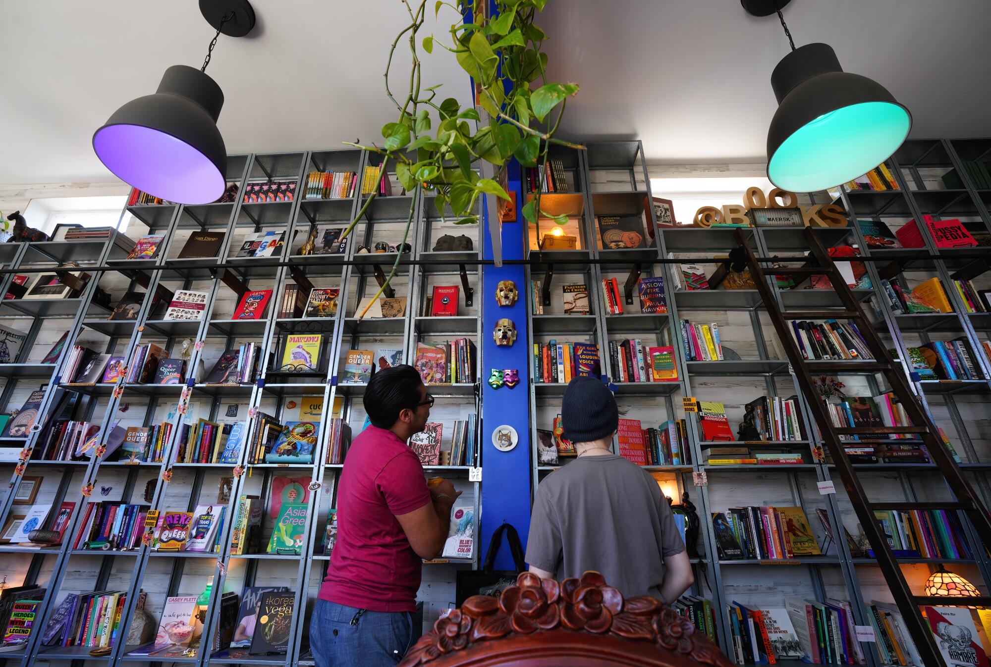 Customers shop at Libélula bookstore, a 700-square-foot space in the Barrio Logan Community in San Diego, CA.