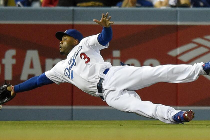 Dodgers left fielder Carl Crawford can't get to a ball hit by Phillies second baseman Chase Utley, who wound up with a double on the play, during a game last month at Dodger Stadium.
